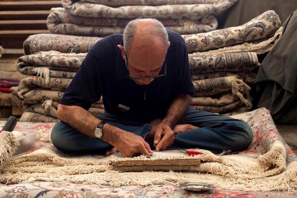 Professional carpet cleaning technician using industrial equipment on luxury living room carpet